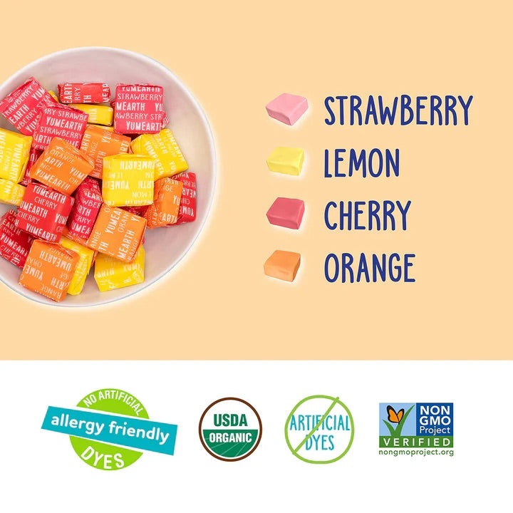Assorted colorful chewys in a bowl with flavor labels on a beige background.