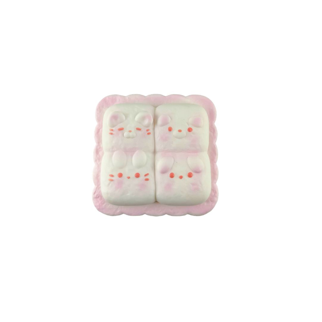 Cheese toast–shaped pink squishy toy with four bunny faces arranged in a square on a white background.