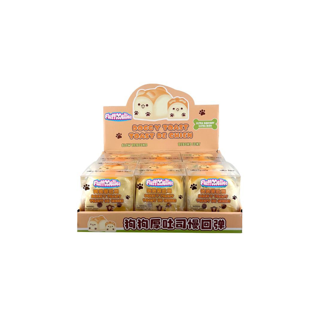 Counter display tray with multiple boxed Fluffiemellies Doggy Toast squishy toys featuring dog‑shaped toast designs and tan packaging.