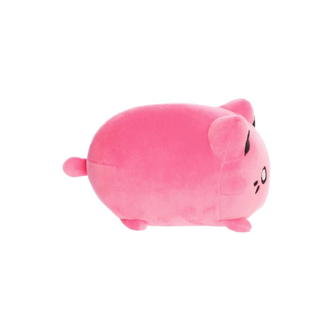 Side view of a small pink plush toy shaped like a rounded cat, with short legs, a tiny tail, black inner ears, and embroidered facial details, shown on a white background.
