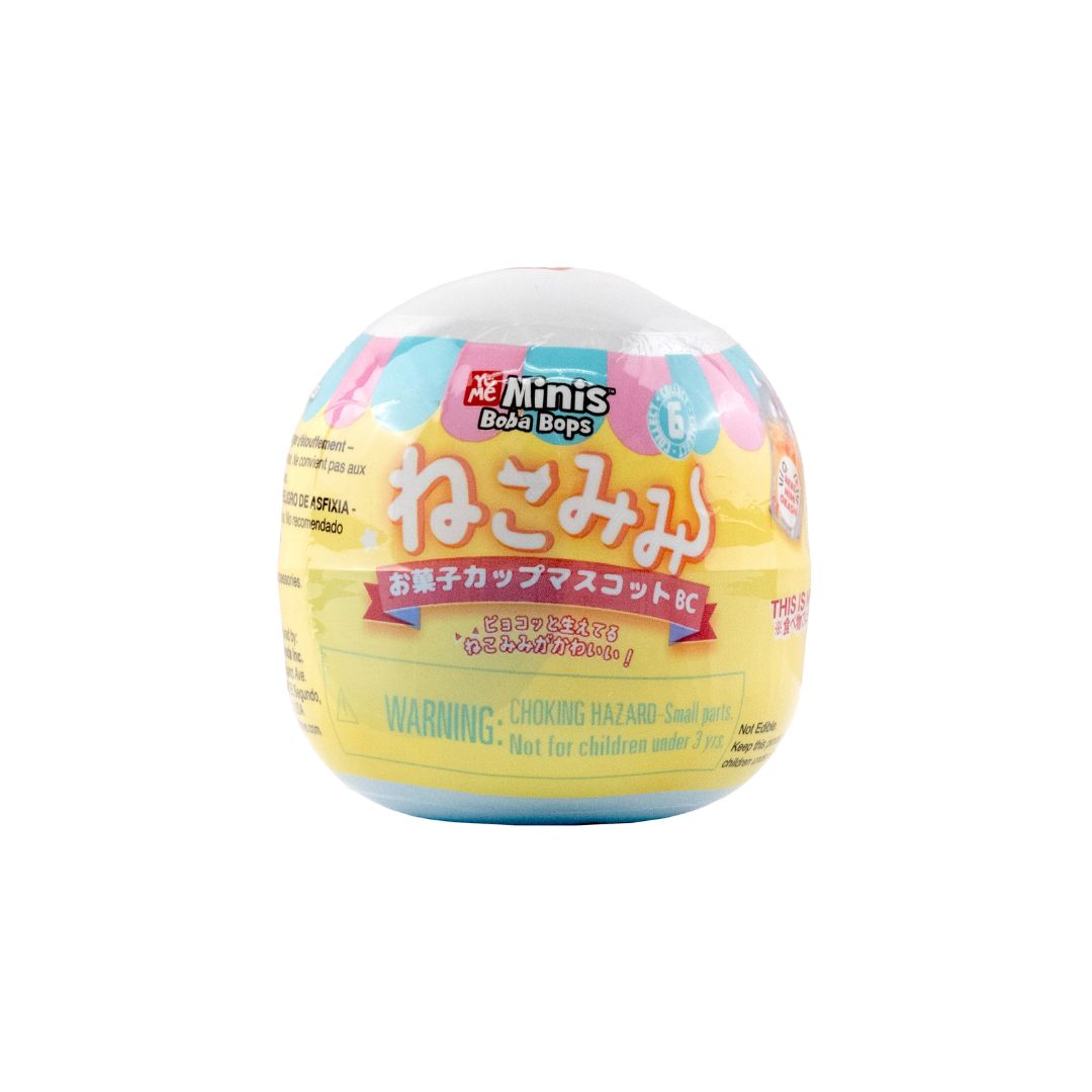 pastel‑colored capsule toy labeled ‘Me Minis Boba Bops’ with Japanese text and a choking hazard warning, shown on a white background.