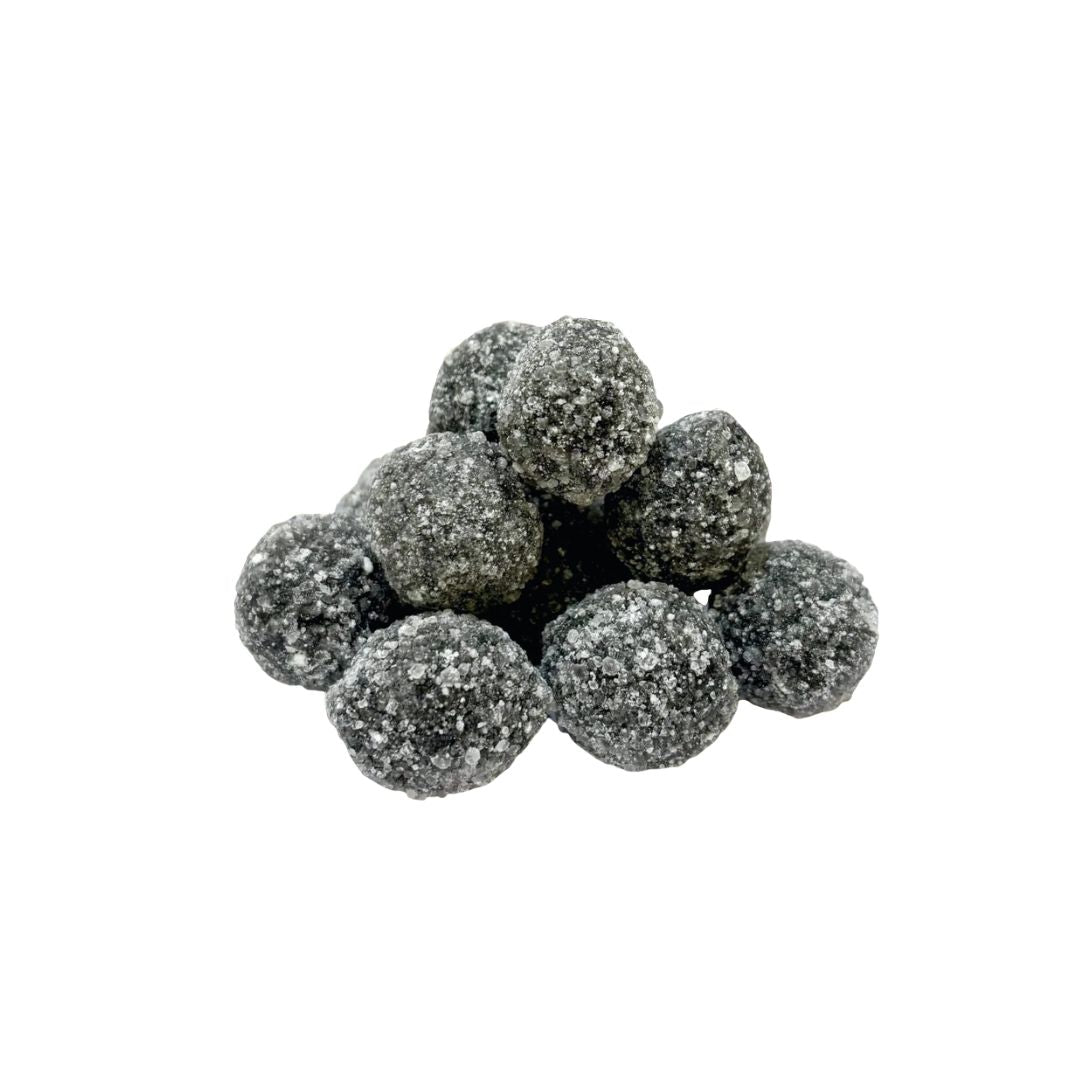 Cluster of dark gray black death sour balls on a white background