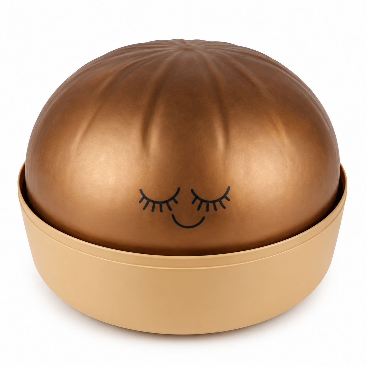 A metallic bronze squishy dumpling with a matching beige base, featuring a simple black line drawing of a sleeping face on the front, set against a plain white background.