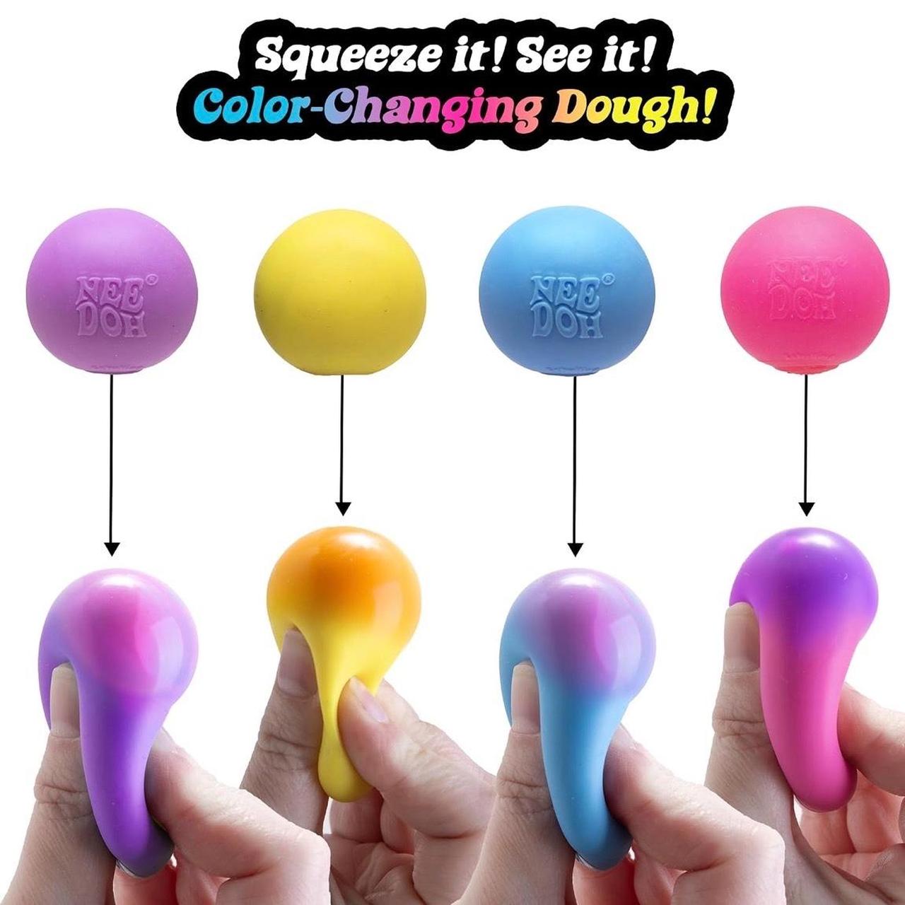 Six color-changing stress relief toys shown in different colors, with hands squeezing them to demonstrate their squishy texture. The top features the text 'Squeeze it! See it! Color-Changing Dough!'.