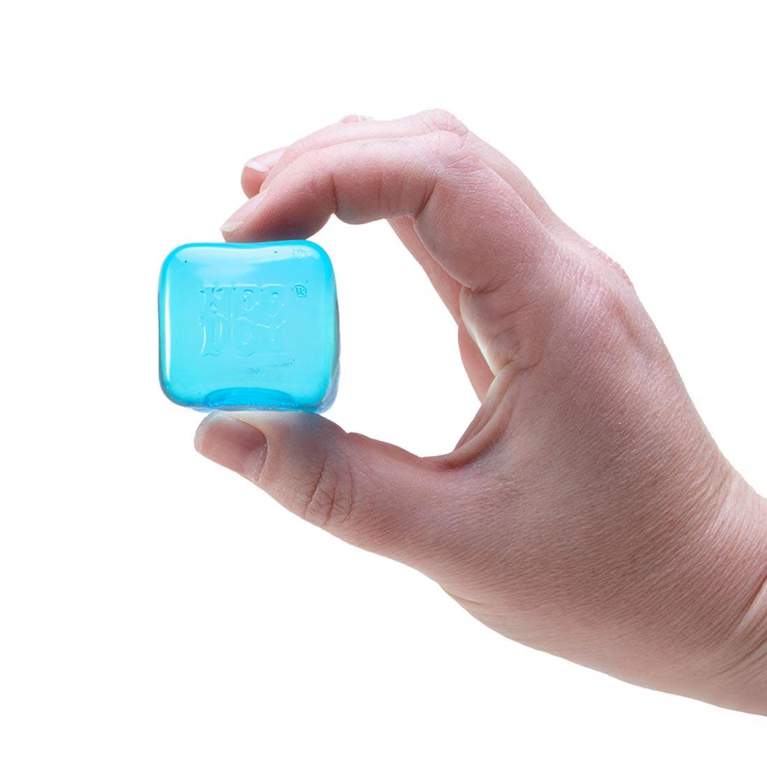 Hand holding a small translucent blue “Nee Doh Nice Ice Baby” cube squeeze toy against a white background