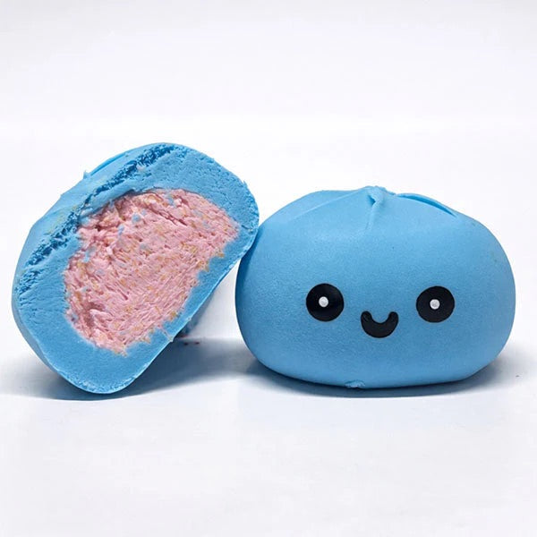 Blue chewy dumpling with a smiley face and pink interior on a white background