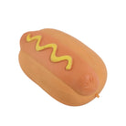 A novelty hot dog squishy toy or prop shaped like a sausage in a bun with a yellow zigzag mustard line, photographed on a clean white background.