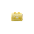 Yellow Donkey Rolls squishy toy shaped like a rolled character with a simple face on a white background.