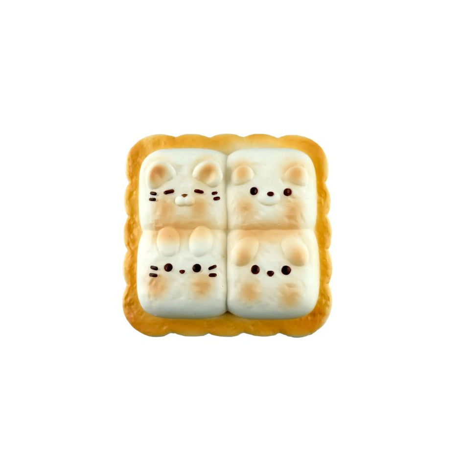 Cheese toast–shaped  brown squishy toy with four bunny faces arranged in a square on a white background.