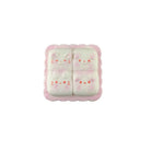 Cheese toast–shaped pink squishy toy with four bunny faces arranged in a square on a white background.