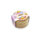 Closed round tan container packaged with a pastel “Lucky Bao Squishy Collectible” label, showing cartoon dumpling characters and product details on the top sleeve, displayed on a white background.