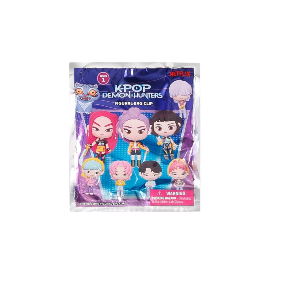  Front of a sealed “K‑Pop Demon Hunters” blind‑bag package labeled “Figural Bag Clip,” showing illustrated cartoon characters from the series on purple and blue packaging with a Netflix logo and a choking‑hazard warning.