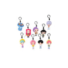  Assorted K‑Pop Demon Hunters character bag‑clip keychains displayed on a white background, each showing a small stylized figurine attached to a black clip, arranged in rows with different hairstyles, outfits, and colors.