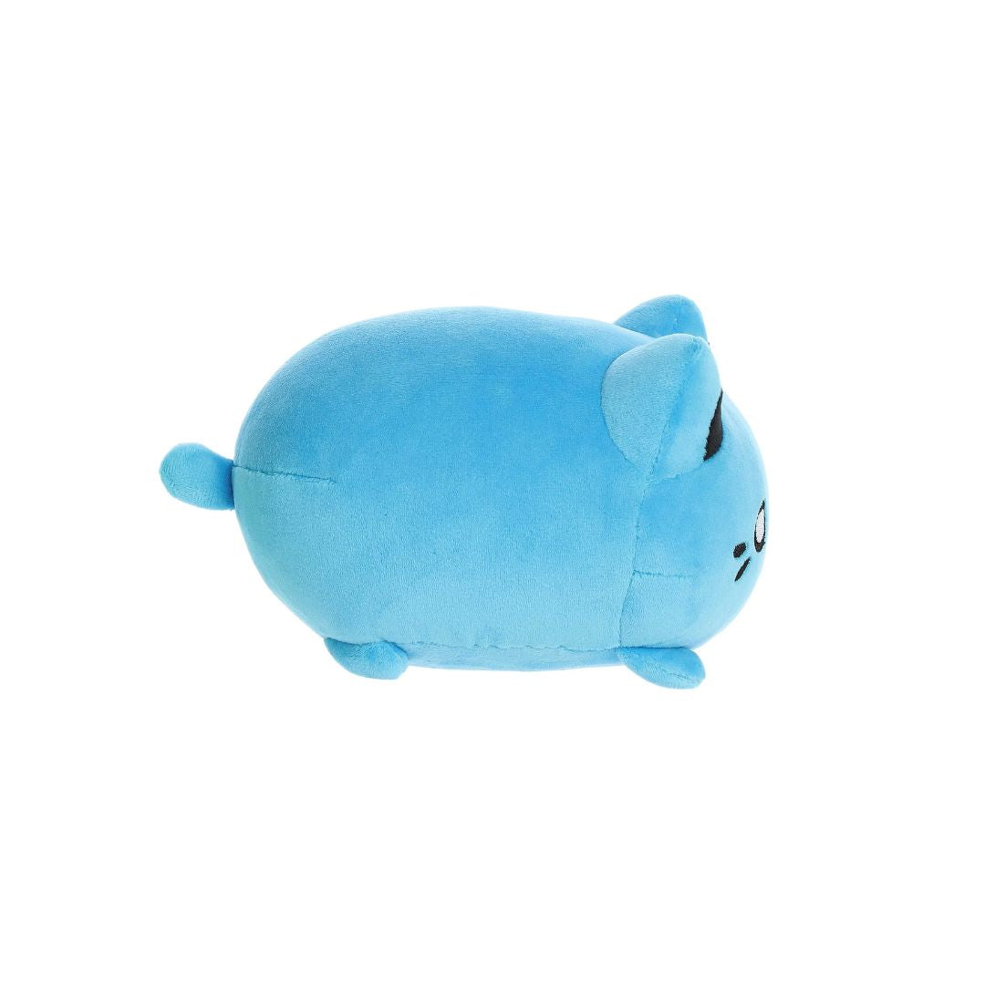 Side view of a small blue plush toy shaped like a rounded cat, with short legs, a tiny tail, black ear tips, and embroidered facial details, shown on a white background.