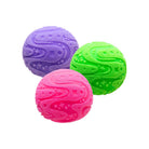Three round textured squishy balls shown on a white background, arranged in a triangular cluster, with raised swirl patterns covering the surfaces. The balls are colored purple, bright green, and bright pink.