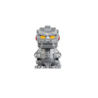 Silver robot‑style collectible figurine with yellow eyes standing upright on a white background.