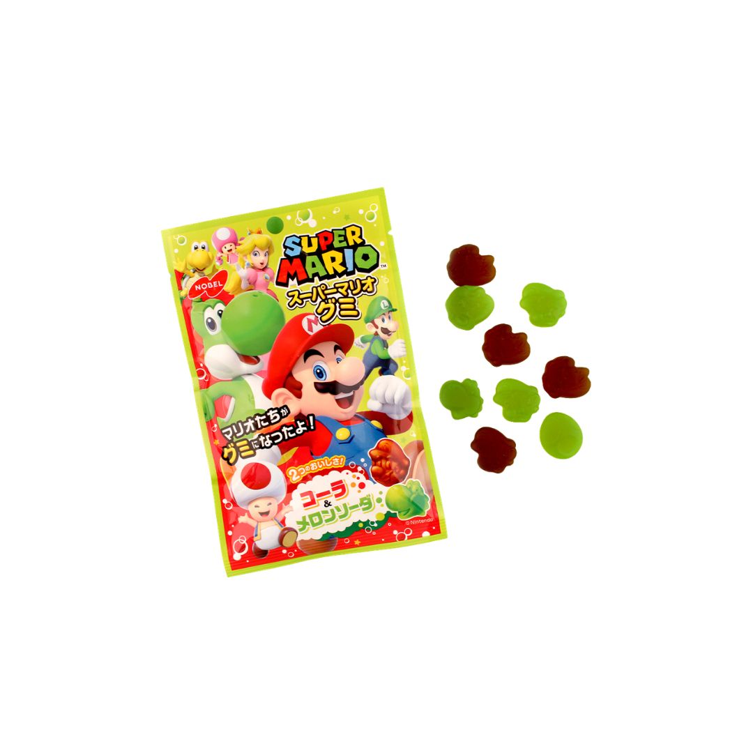 Super Mario Gummi candy package with green and brown gummy shapes displayed beside it on a white background