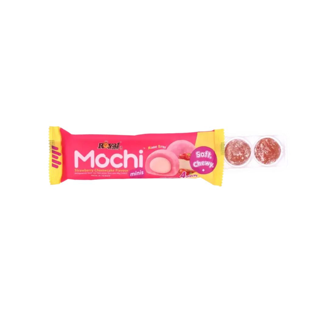 A bright pink package of strawberry cheesecake–flavored mochi minis, labeled “Soft & Chewy,” with an image of a pink-filled mochi on the front, placed next to a small clear plastic tray holding two round mochi pieces dusted with powder on a plain white background.