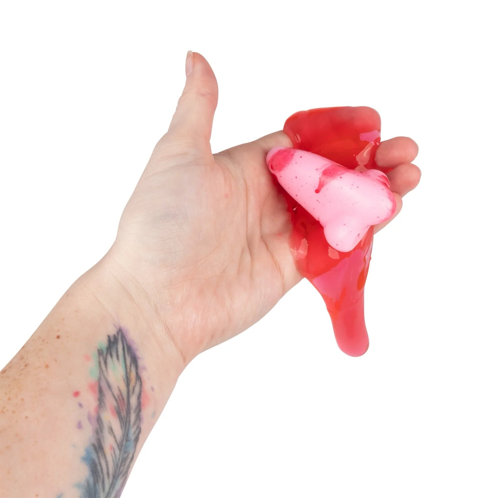 Hand squeezing a red and pink gel-like substance against a white background