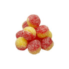 Cluster of red and yellow rancid custard ultra sours on a white background