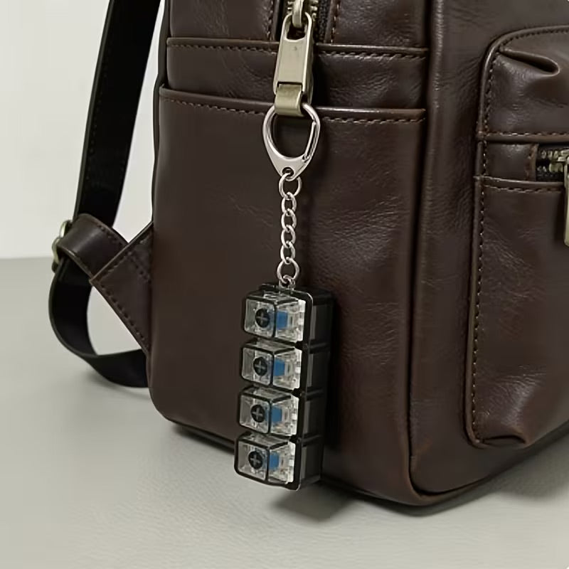 keyboard clicker keychain attached to brown bag