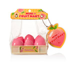 A toy set of six pink plastic peaches arranged in a clear plastic bag with a cardboard header labeled 'MINI FRUIT MART' and a hanging peach-shaped tag, on a white background.