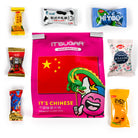 A pink bag of IT'S SUGAR Chinese candy mix surrounded by various individually wrapped Chinese snacks on a white background.