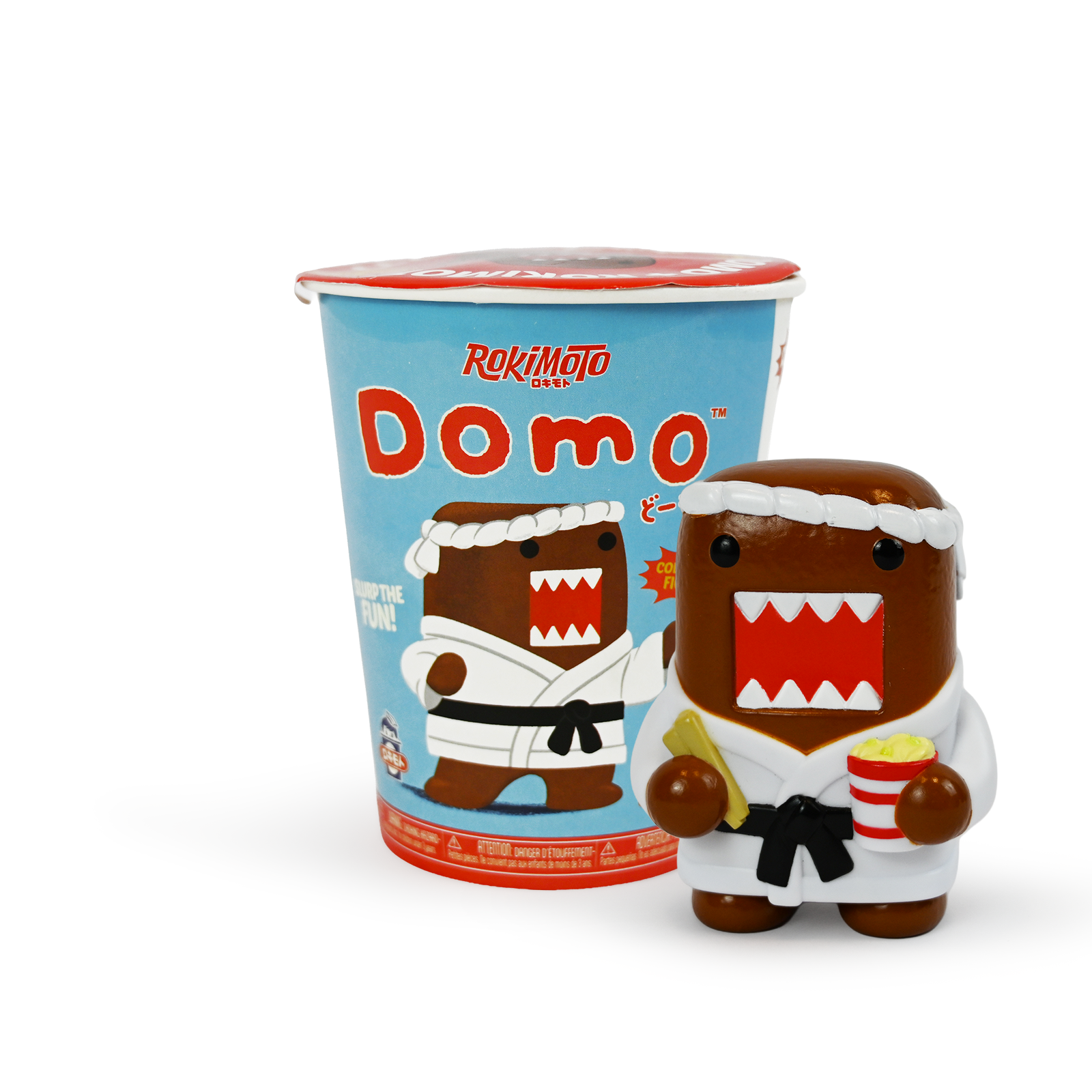 Light blue ramen cup with red text that says Rokimoto Domo and a picture of Domo in a Karate uniform next to a figure of Domo in a Karate uniform