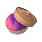 Tan Dumpling container with a pink and purple squishy dumpling inside