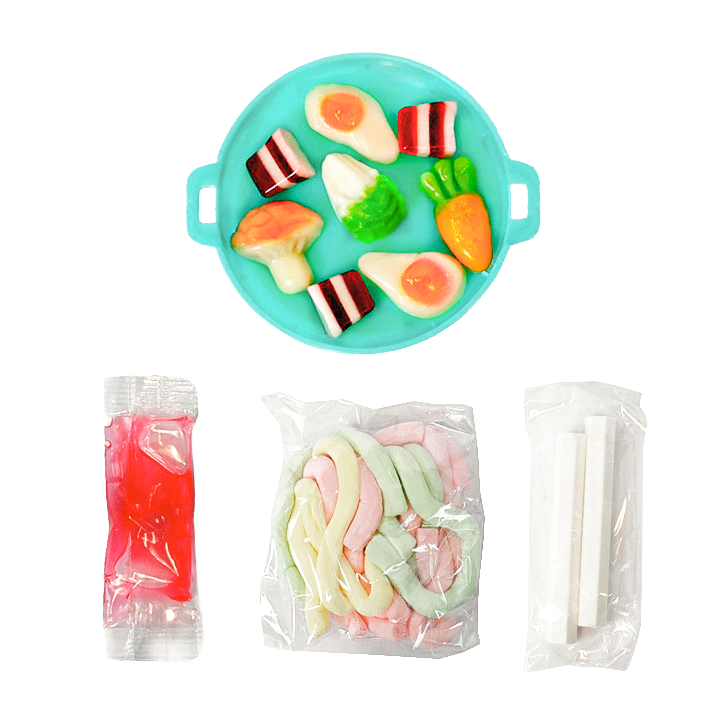 A hot pot–style candy set with food-shaped gummies in blue liquid, shown alongside separate packets of red liquid, pastel gummy strips, and white sticks on a white background.