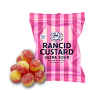 A 100g bag of Rancid Custard Ultra Sour candy next to several individual sour candies, set against a plain white background.
