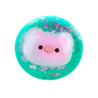 Pink pig inside teal squeeze ball with purple glitter