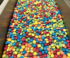 Colorful milkless chocolate candies in a container