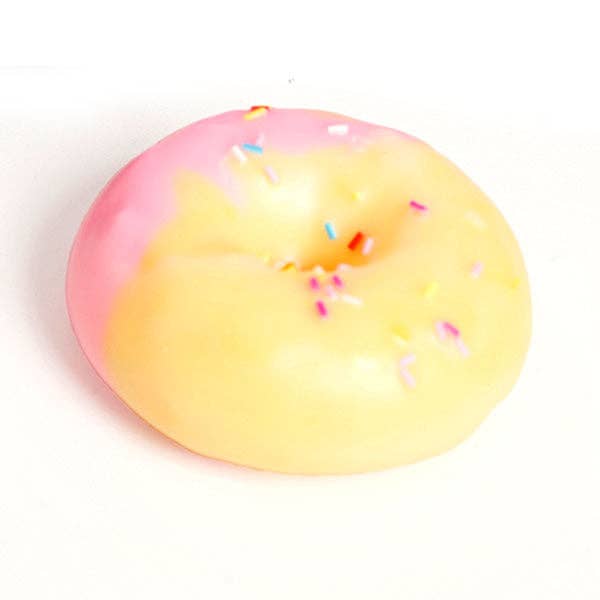 A novelty squishy toy shaped like a donut, featuring a two-tone pink and pale yellow glaze with colorful sprinkles, on a plain white background.