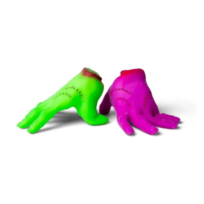Two colorful monster hand-shaped toys, one green and one pink, on a white background.